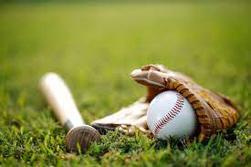 baseball history picture of a bat, glove and ball just laying on the green field