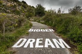 all things self help a picture of a road with the words dream bigger on the pavement