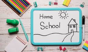 homeschool an image on a whiteboard with the words Home School and a school house pictured. Also color pencils and other supplies around